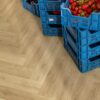 SPC herringbone flooring Quick-Step Ciro Botanic Beige installed on floor and berrys and jam in boxes