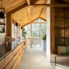 vinyl-flooring-tiles-quick-step-illume-sandstone-concrete Vinyl flooring tiles installed on a 1-st floor kitchen. Rustical stile with wooden beams and boards ceiling. Rustical wooden kitchen furniture facade with dark marble top. Rustical golden wall tiles.