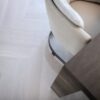 Herringbone parquet Bauwerk Monopark Oak Natur 15 Farina B-Protect® white matt lacquer – close-up of the light oak floor under a chair and table
